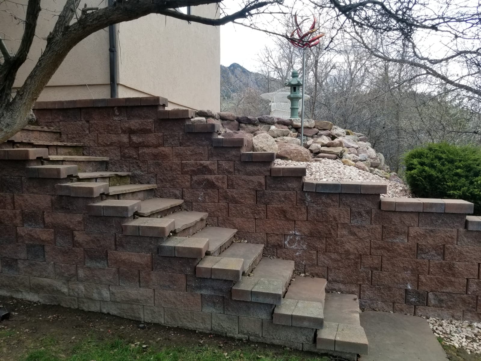 Before photo - retaining wall with mountain backdrop